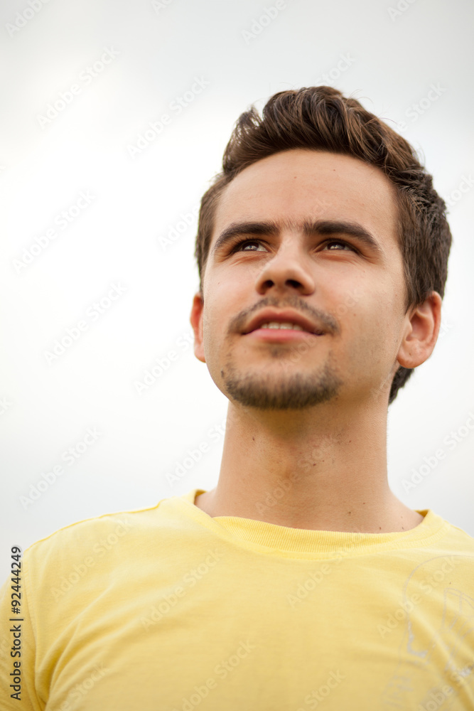 Fototapeta premium Portrait of a young man looking happily ahead