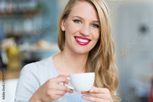 Woman drinking coffee at cafe 