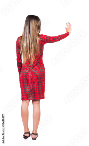 back view of young woman presses down on something