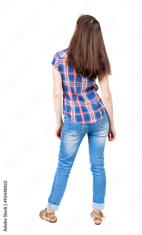 back view of standing young beautiful woman in jeans. back view of standing young beautiful woman in jeans.