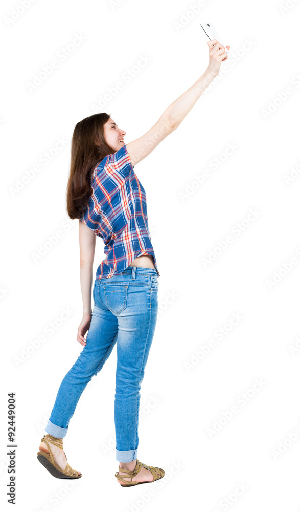 back view of standing young beautiful woman and using a mobile back view of standing young beautiful woman and using a mobile