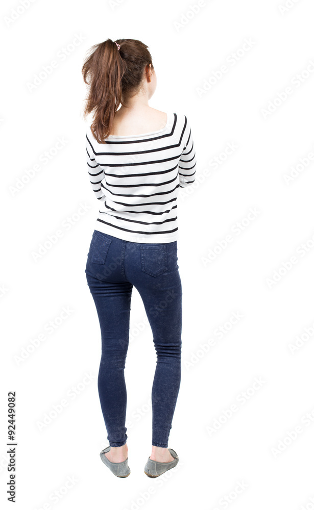 back view of standing young beautiful woman in jeans. back view of standing young beautiful woman in jeans.
