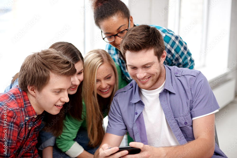 group of happy students with smartphone at school group of happy students with smartphone at school