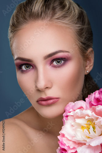 Close up portrait of pretty woman with peony