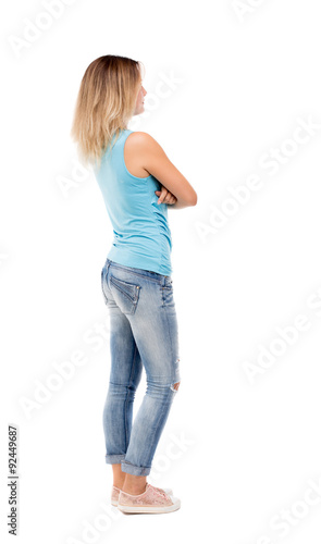 back view of standing young beautiful woman.
