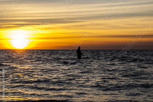 Angler fishing at the coast in an Autumn sunset © brianholm