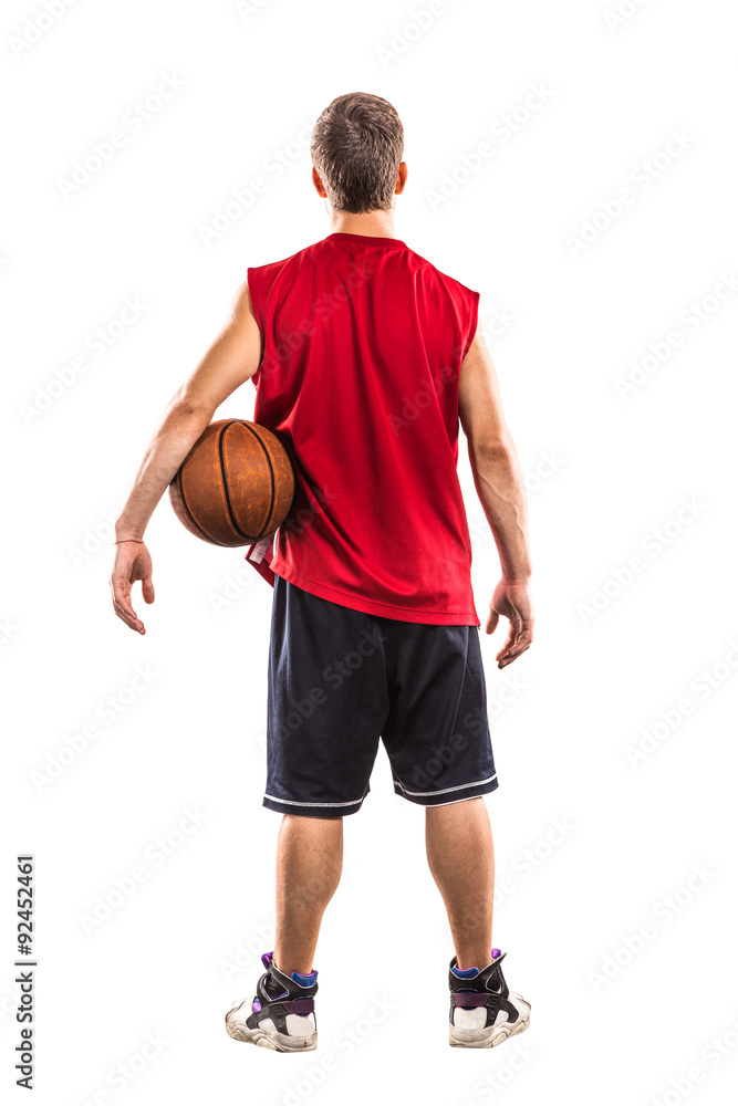 Basketball player standing with ball from the back isolated on Basketball player standing with ball from the back isolated on