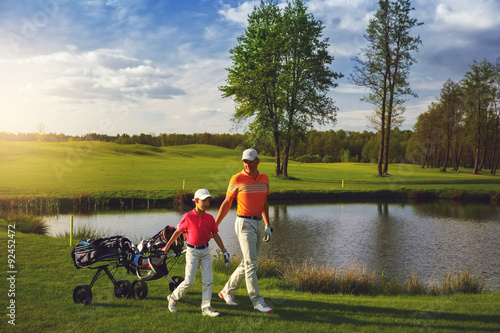 Father with son at golf field