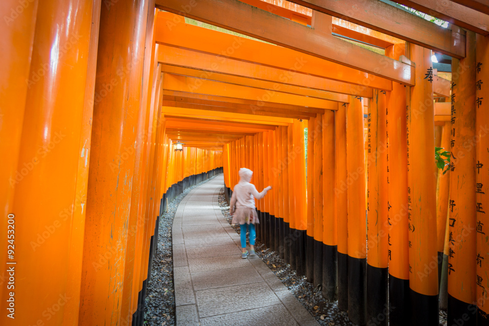 Torii gates in Fushimi Inari Shrine with blurred kid, Kyoto Torii gates in Fushimi Inari Shrine with blurred kid, Kyoto