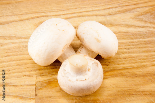 Champignon mushrooms on wooden board