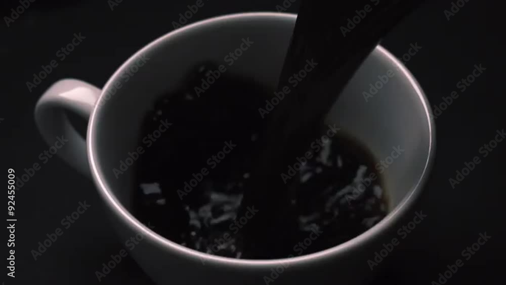 Pouring coffee on dark background