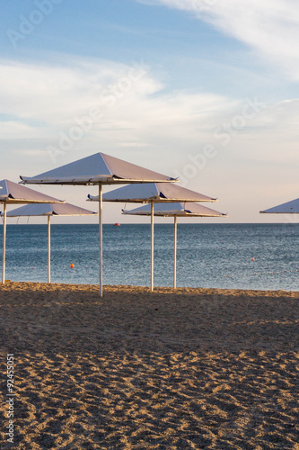 Umbrellas on the beach on the black sea © Viktoriya09