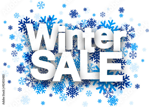 Winter sale paper sign over snowflakes.