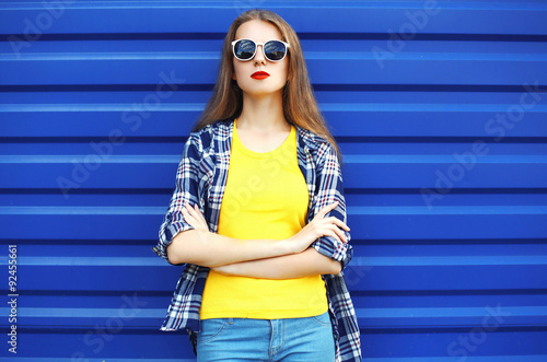 Fashion portrait of pretty girl in sunglasses and colorful cloth