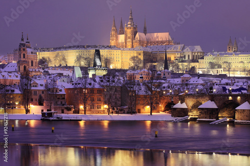 Night romantic colorful snowy Prague gothic Castle with Charles Bridge, Czech Republic © Kajano