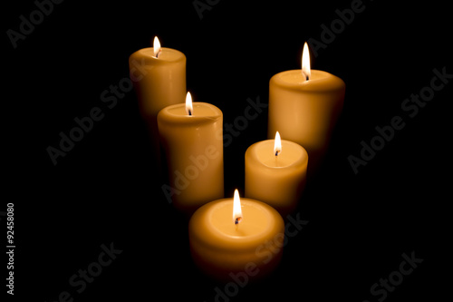 five Candles on black background