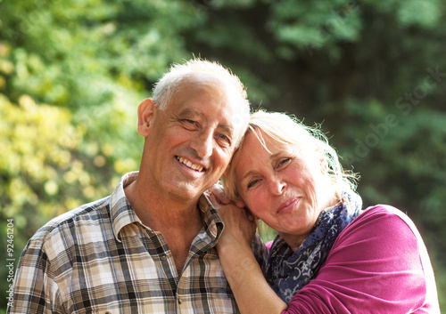 Close up portrait of a happy older couple smiling and showing affection