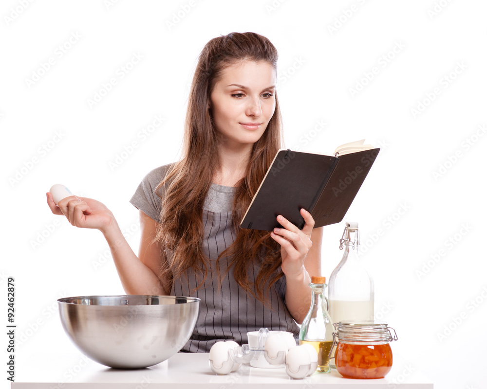 Woman baking at home following recipe Woman baking at home following recipe