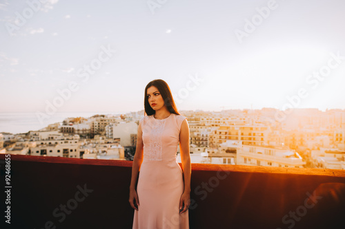 Fototapeta Naklejka Na Ścianę i Meble -  Beautiful brunette young woman in a white evening dress. setting