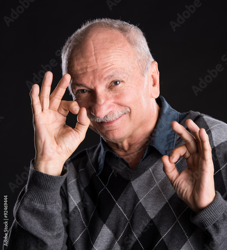 Successful eldrly man showing ok sign photo