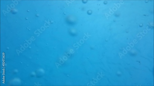 Bubbles underwater in clean blue water floating around