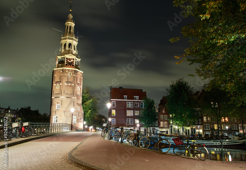 Montelbaans Tower (Montelbaanstoren) in night. Amsterdam, Netherlands. / It was built in 1516 for the purpose of defending the city.