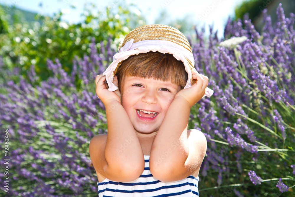 smiling girl with straw hat in lavender field