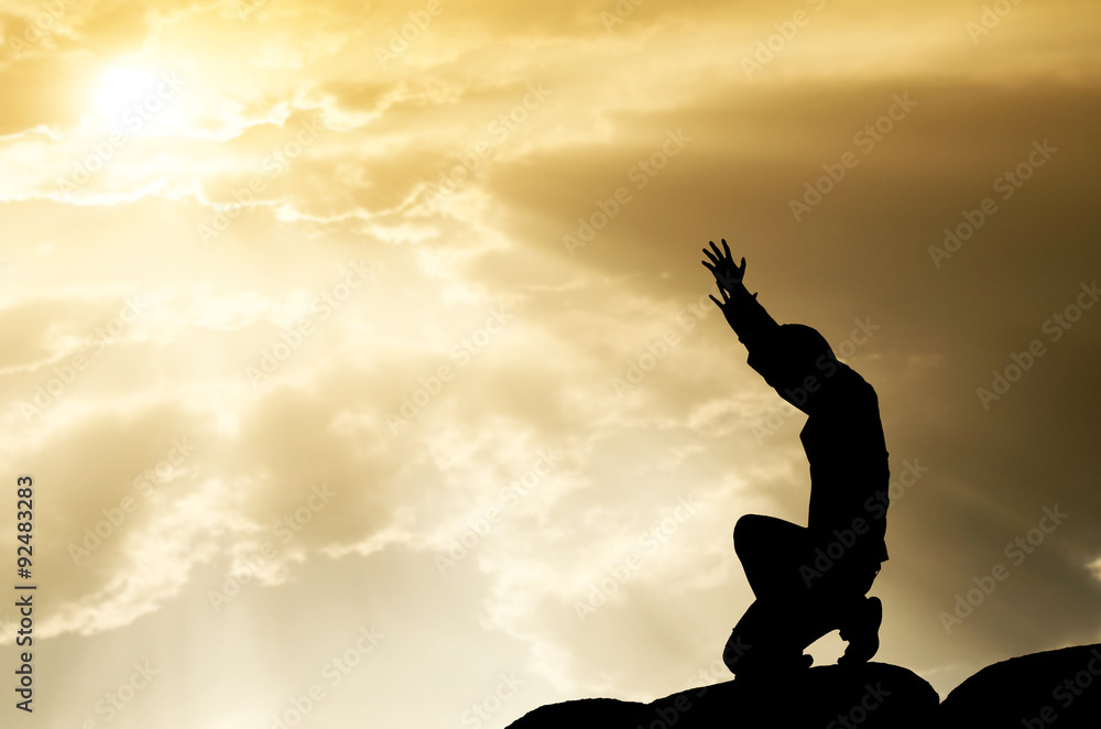 praying man on beautiful sky background