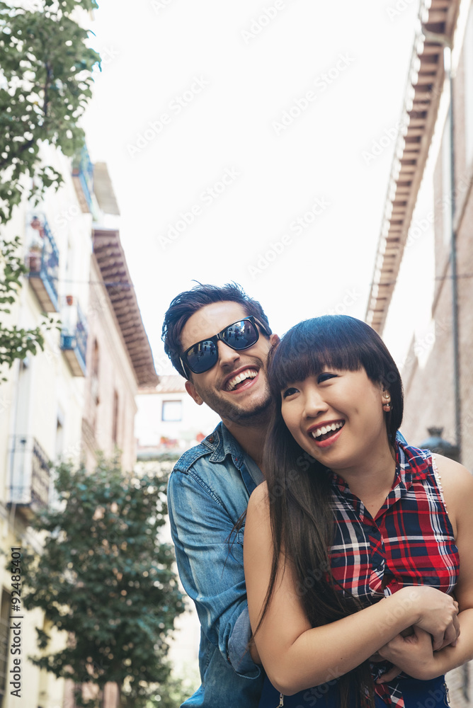 Portrait of happy beautiful couple isolated on street