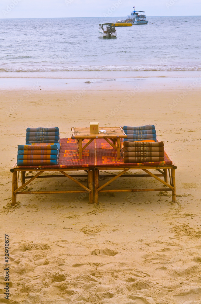 Beach chair and umbrella on sand beach. Concept for rest, relaxa Beach chair and umbrella on sand beach. Concept for rest, relaxa