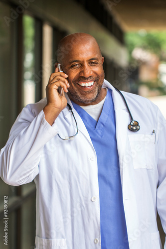 African American Doctor texting on the phone.