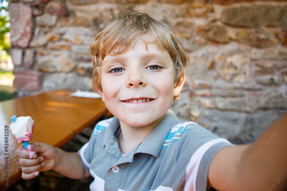 Kid boy taking selfie with mobile phone Stock Photo | Adobe Stock