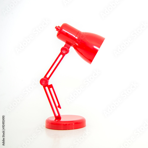 Modern red color desk lamp on white background