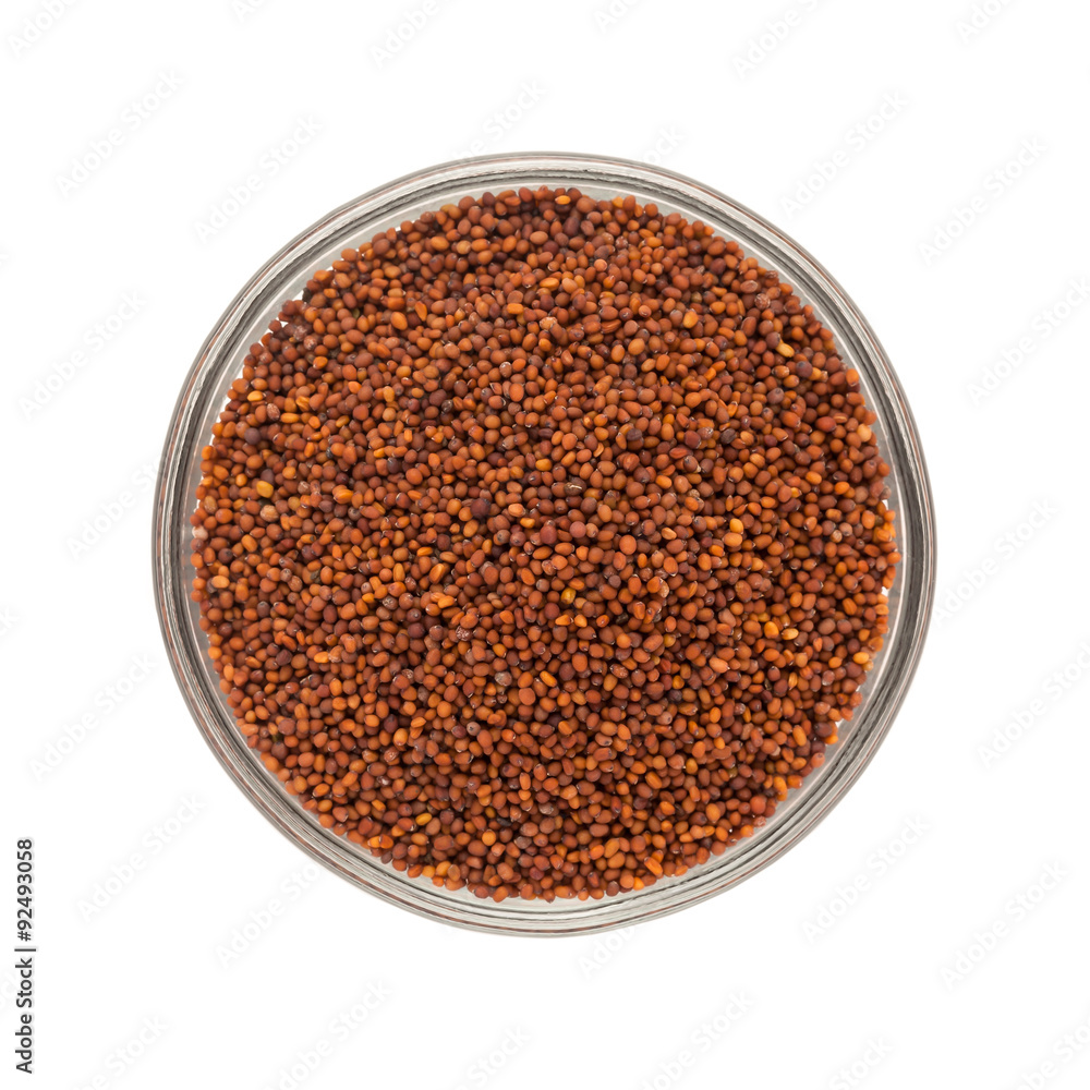 Top view of Organic Small Brown Mustard Seeds (Brassica juncea) in glass bowl isolated on white background. Top view of Organic Small Brown Mustard Seeds (Brassica juncea) in glass bowl isolated on white background.