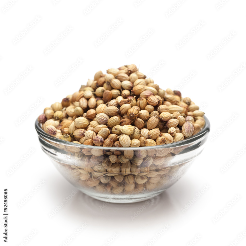 Front view of Organic Dried coriander seeds (Coriandrum sativum) in glass bowl isolated on white background. Front view of Organic Dried coriander seeds (Coriandrum sativum) in glass bowl isolated on white background.