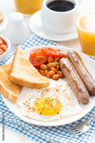 Traditional delicious English breakfast with sausages, top view