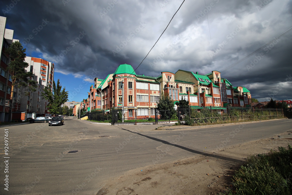 facade of the house street on a background of clouds