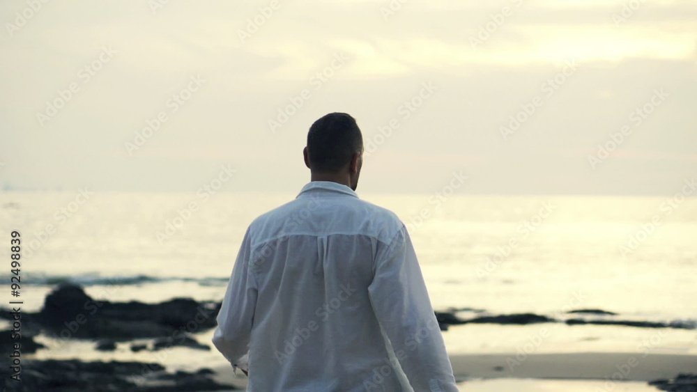 Successful man raising arms to the sky standing on the beach, super slow motion
Successful man raising arms to the sky standing on the beach, super slow motion