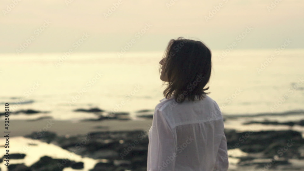 Young, happy woman walking on beach
Young, happy woman walking on beach
