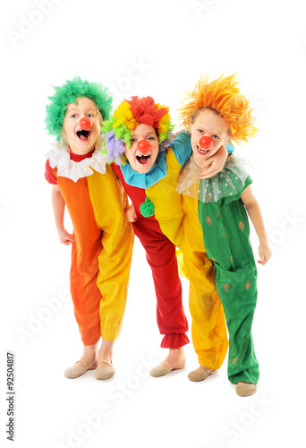 Happy children dressed up as colorful funny clowns
