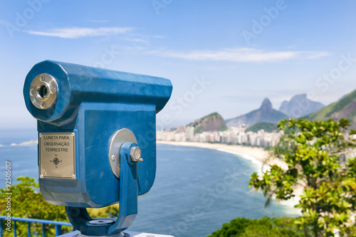 Scenic overlook view of Copacabana Beach in Rio de Janeiro, Brazil with a telescope [English translation of sign: Telescope for viewing of landscape]