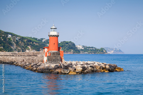Red lighthouse tower on the breakwater, Ischia