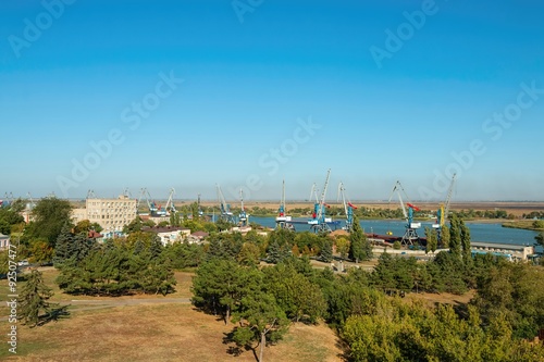 Water area of the Don river and industrial port with crane, established in coastal street in Azov.