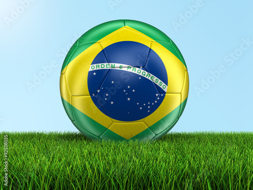 Soccer football with Brazilian flag on grass. Image with clipping path
