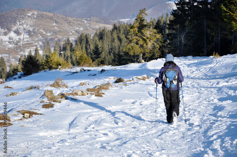 Woman trekking in the mountains at winter