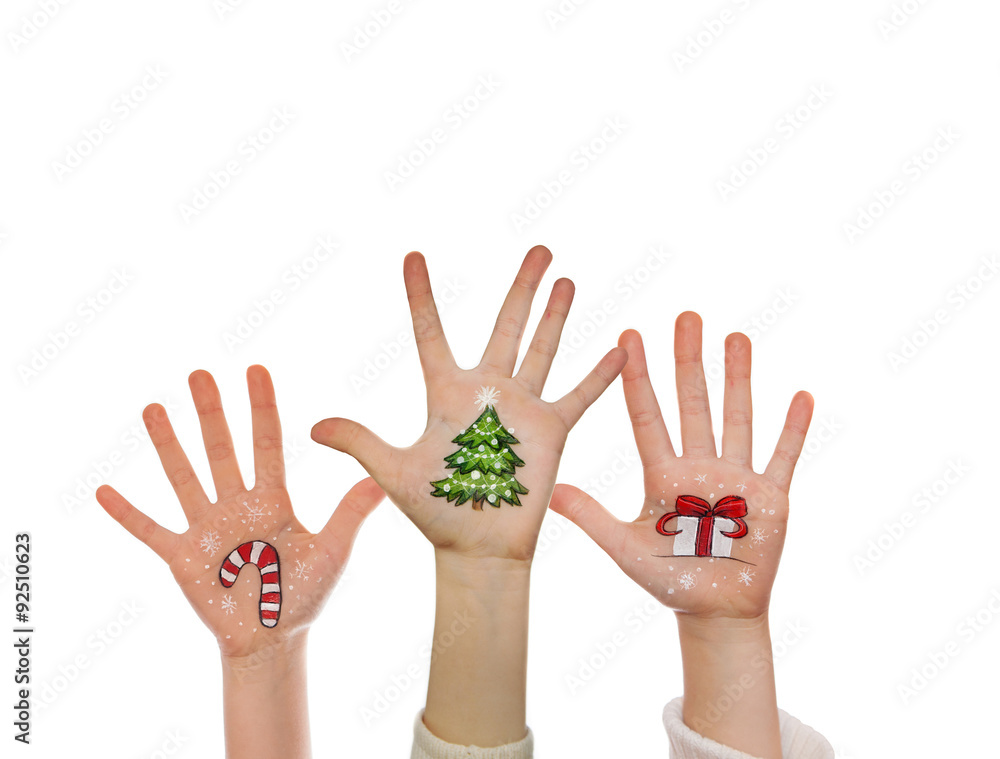 Christmas symbols painted on kid's hands. Santa, snowman, Christmas tree, present box, reindeer etc Christmas symbols painted on kid's hands. Santa, snowman, Christmas tree, present box, reindeer etc