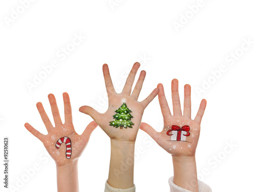 Christmas symbols painted on kid's hands. Santa, snowman, Christmas tree, present box, reindeer etc