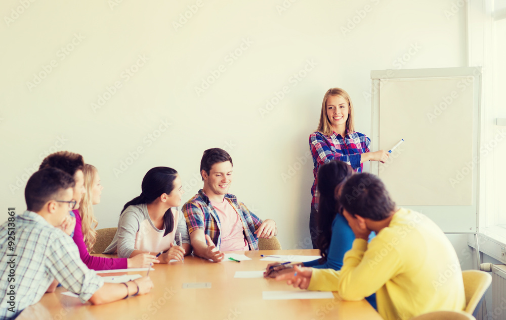 group of smiling students with white board group of smiling students with white board
