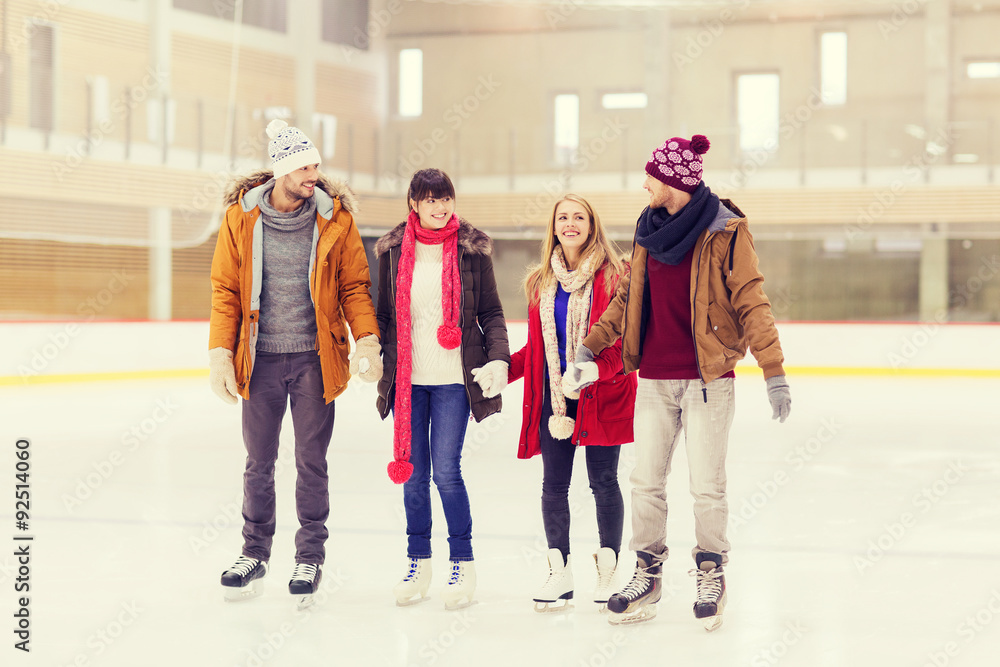 happy friends on skating rink