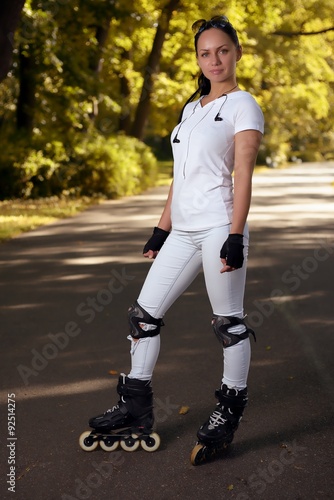 Beautiful girl on roller skates in park